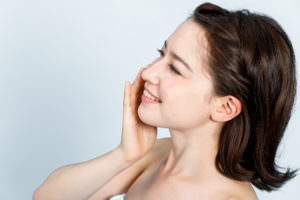 young caucasian woman portrait on white background. skincare concept.